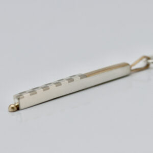 Checkerboard Bar Pendant With 22K and 14K Gold is shown from the side.