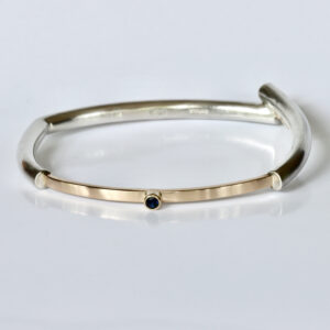 Overlapping Bangle with Sapphire.