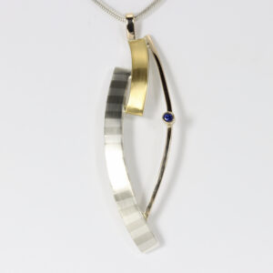Large mixed-metals curvy Pendant with a Sapphire.