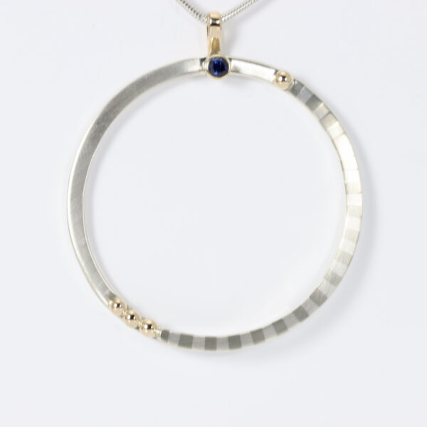 Large Sterling Circular Pendant with a striped pattern, 14k gold balls, and a Sapphire