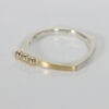 Squarish shaped narrow sterling silver ring with 22k and 14k gold accents.