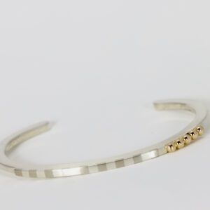 Striped cuff with five solid 14k gold balls.