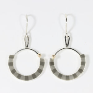 Dangle circular earring with a striped pattern. Hand-fabricated in sterling silver with a 14k ball.