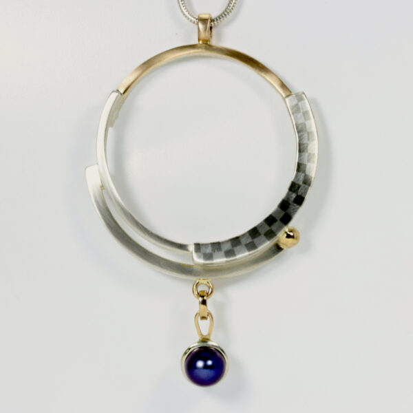 Spiral Circular Pendant with a checkerboard pattern and a black pearl.