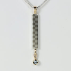 Long Narrow Checkerboard Pendant with a dangling aquamarine set in 14k gold.