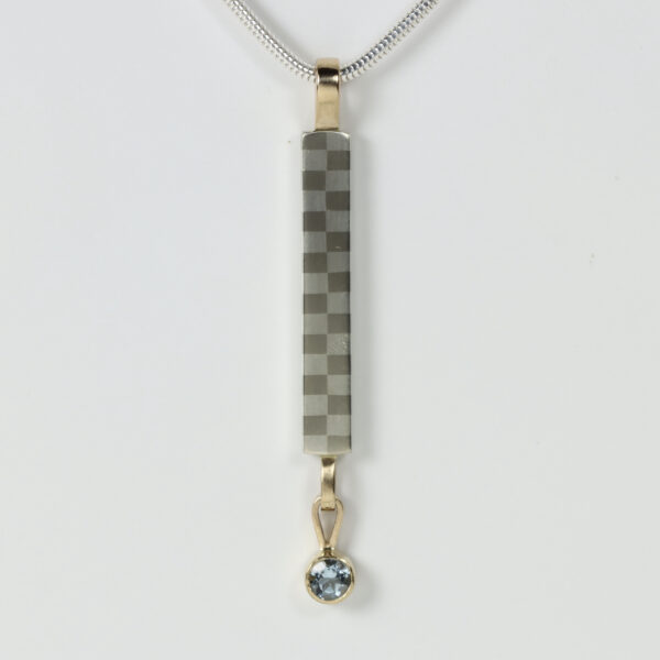 Long Narrow Checkerboard Pendant with a dangling aquamarine set in 14k gold.