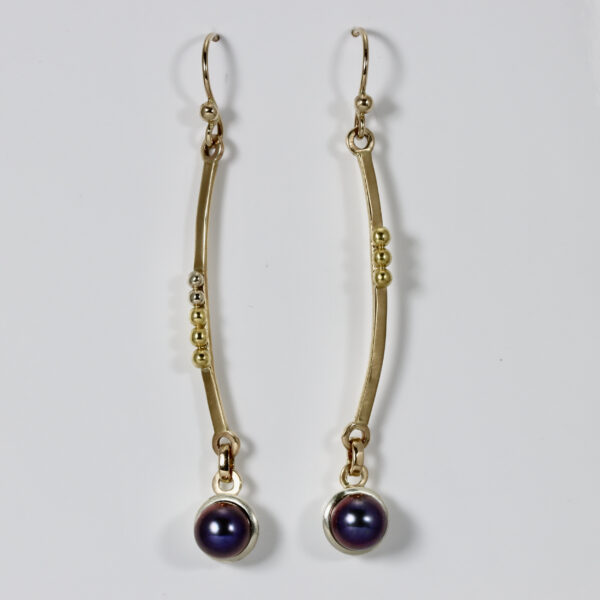 Subtlety unmatched gold dangles. Hand-fabricated in 18, 14k, and 22k gold with a blackpearl.