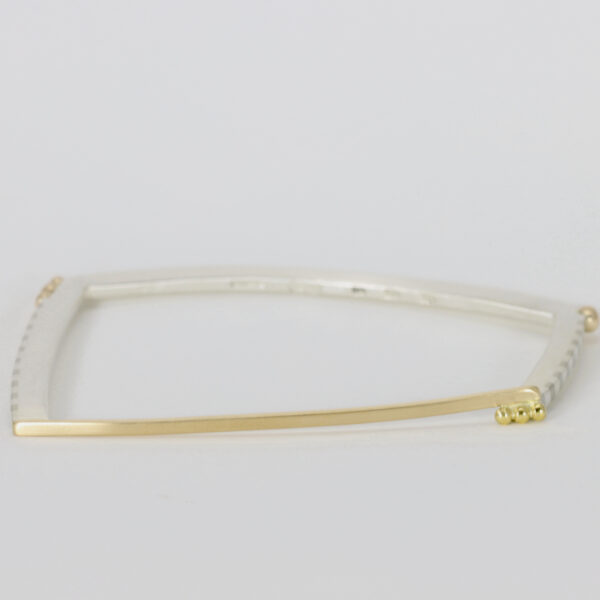 Gold and sterling silver bangle with stripes.