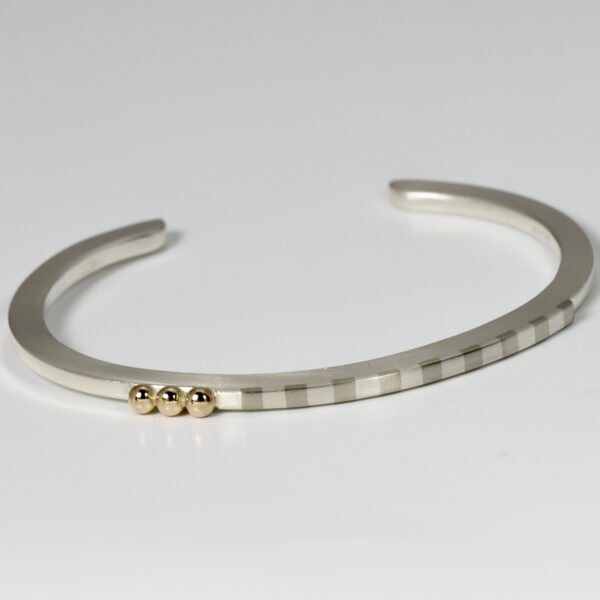 Striped cuff with three 14k gold balls.