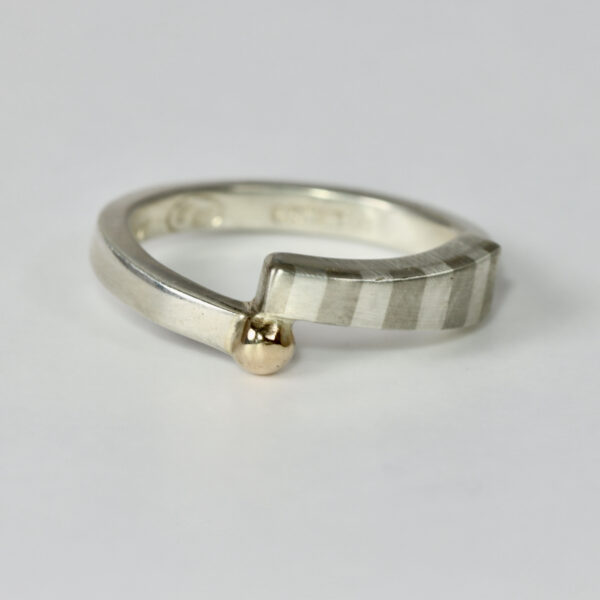 Offset striped ring in sterling silver with a solid 14k gold ball.