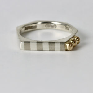 Octagon shaped ring. Striped across the top with three solid 14k balls.