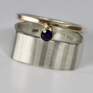 Striped wide double band with a sapphire.