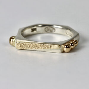 Textured octagon ring fabricated in sterling silver with 14k texture and solid gold balls.