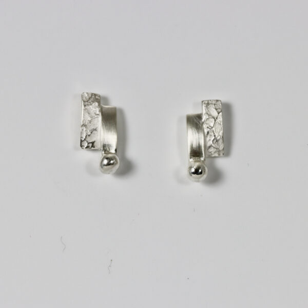 Rectangular stud in textured and smooth sterling silver with a sterling ball at the bottom of the earring.