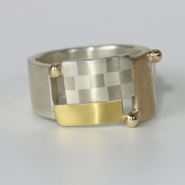 Contemporary mixed metal ring with a checkerboard pattern and three 14k balls. Hand-fabricated in sterling silver, 14k, and 22k gold.