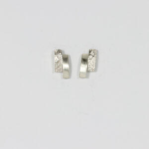 Small stud earring in sterling silver. Offset rectangular shapes. One textured, one smooth.