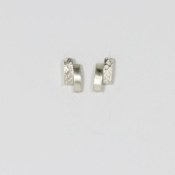 Small stud earring in sterling silver. Offset rectangular shapes. One textured, one smooth.