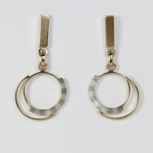Mixed metal earrings with a striped pattern and dangling circles. Hand fabricated in sterling silver and 14k gold.