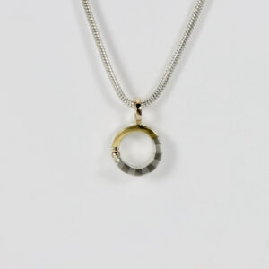 Little circular mixed-metal Pendant. Hand fabricated in sterling silver, 14k, and 22k gold.