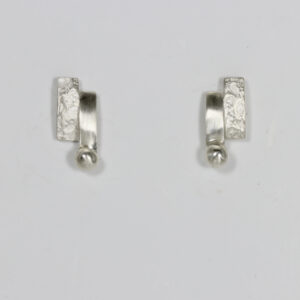 Textured and smooth stud with a ball. fabricated in sterling silver.