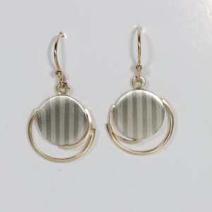 Striped circle accentuated with 14k gold dangle earrings.
