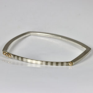 Trapezoid striped bangle bracelet with four 14k gold balls.