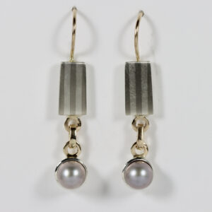 Contemporary pearl earrings. Hand-fabricated in sterling silver and gold with a subtle striped pattern and a grey pearl.