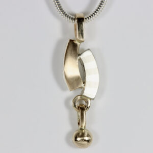 Mixed-metal curvy pendant with a striped pattern and a dangling gold ball.