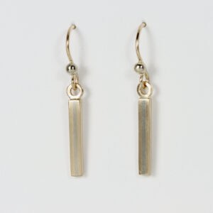 A dangle earring alternating stripes of 14k yellow and 14k white gold. The earring has a Matt finish and dangles from a 14k wire.
