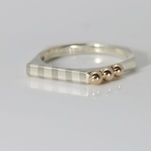 Hexagon shaped ring with a marriage of metals striped pattern and three 14k solid balls.