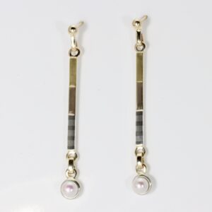 Modern Mixed metals long narrow dangle earrings with a dangling white pearl.
