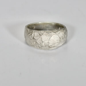 Sterling silver organic pattern textured ring. The ring is domed and tapers narrower in the back for a comfortable fit.